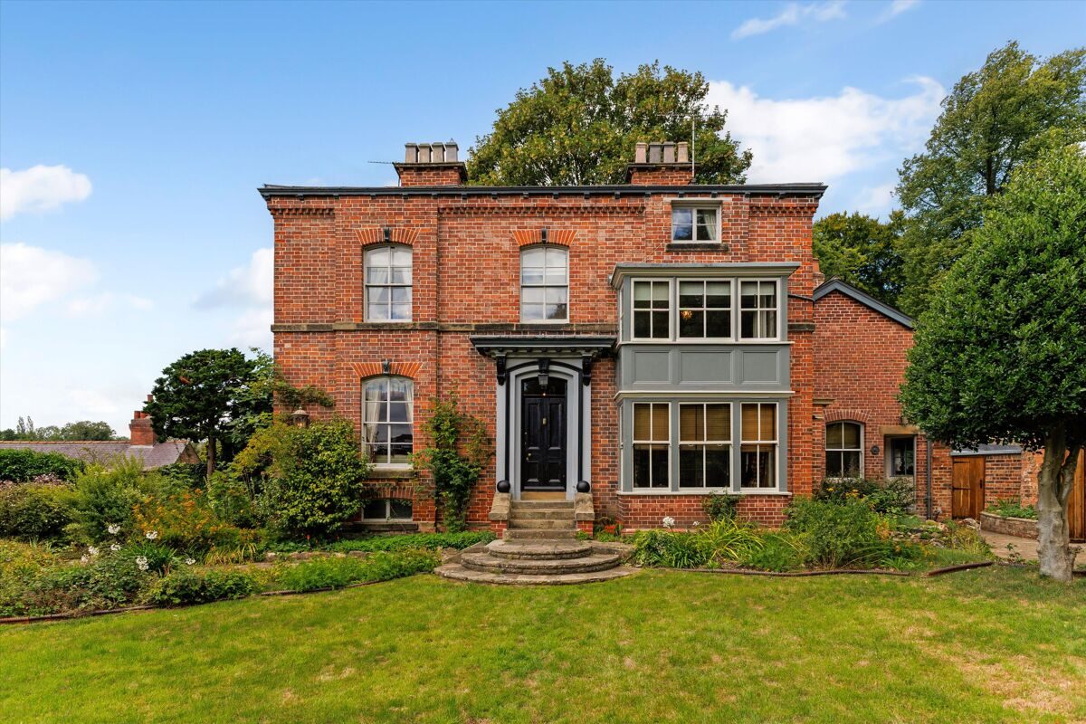 Victorian red-brick house with a well-kept front garden