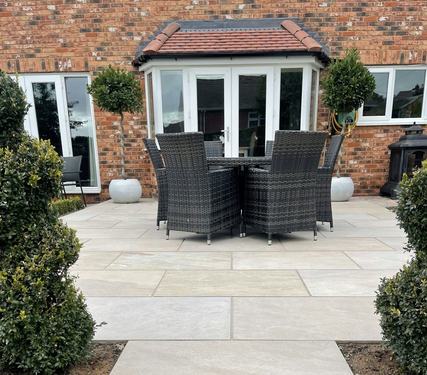 Newly installed natural stone patio with garden furniture
